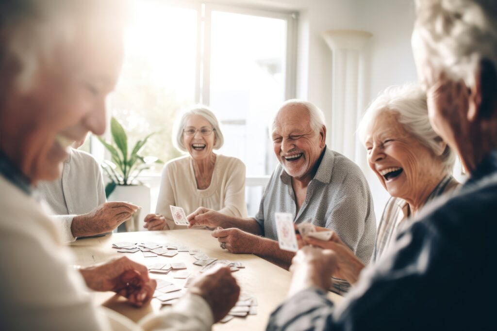 Seniors laughing and playing cards with other community members