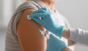 Healthcare professional administering a vaccine to reduce measles risk for seniors